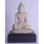 A LARGE 19TH CENTURY INDIAN CARVED WHITE MARBLE FIGURE OF A BUDDHA modelled upon an ebonised base.