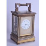 A LATE 19TH CENTURY FRENCH REPEATING BRASS CARRIAGE CLOCK with engine turned dial and black