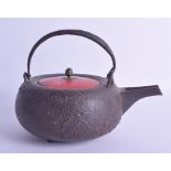 AN 18TH/19TH CENTURY JAPANESE EDO PERIOD IRON TEAPOT AND COVER with red lacquer top, decorated