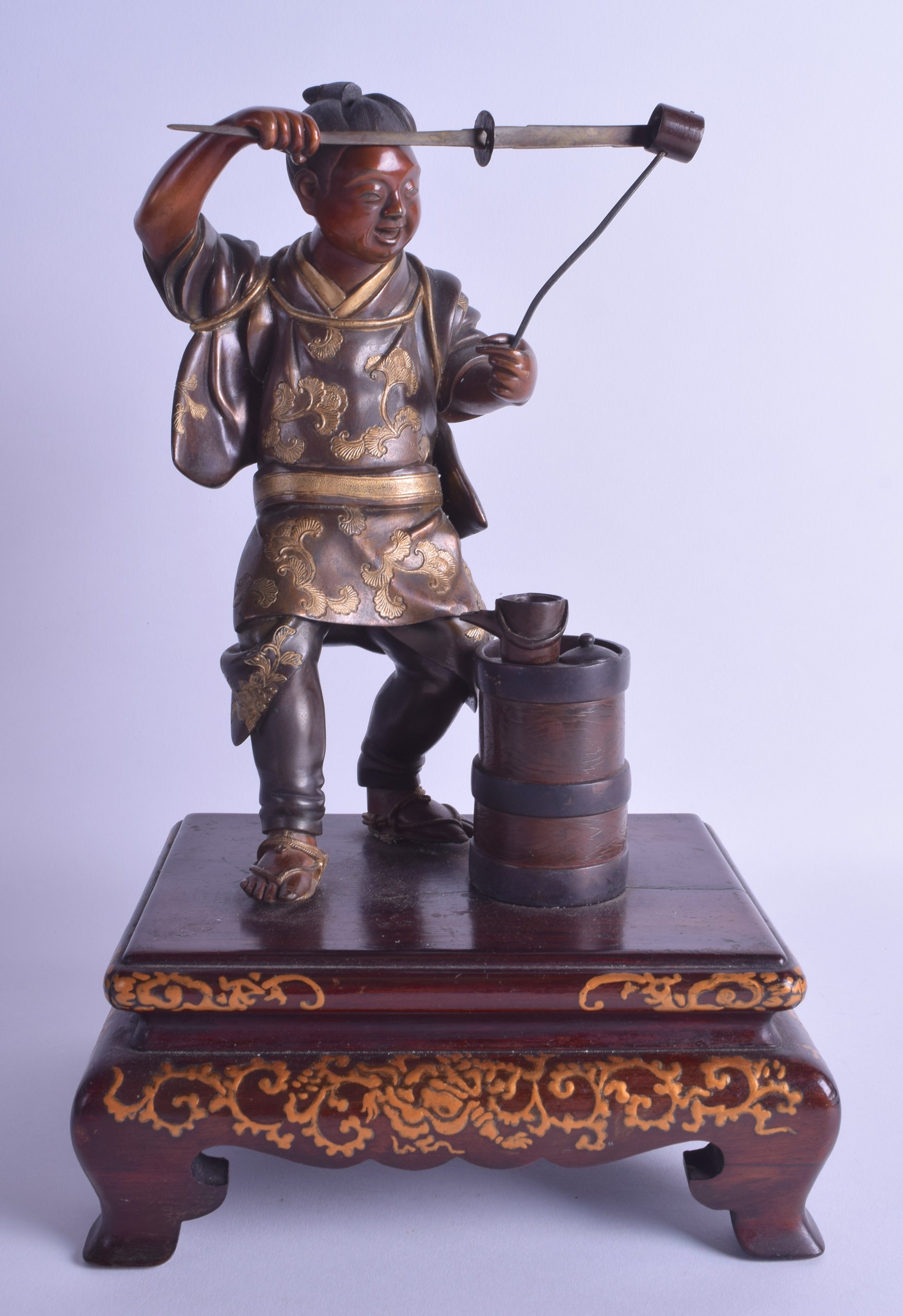 A GOOD 19TH CENTURY JAPANESE MEIJI PERIOD BRONZE OKIMONO by Miyao, modelled as a male wearing gilt