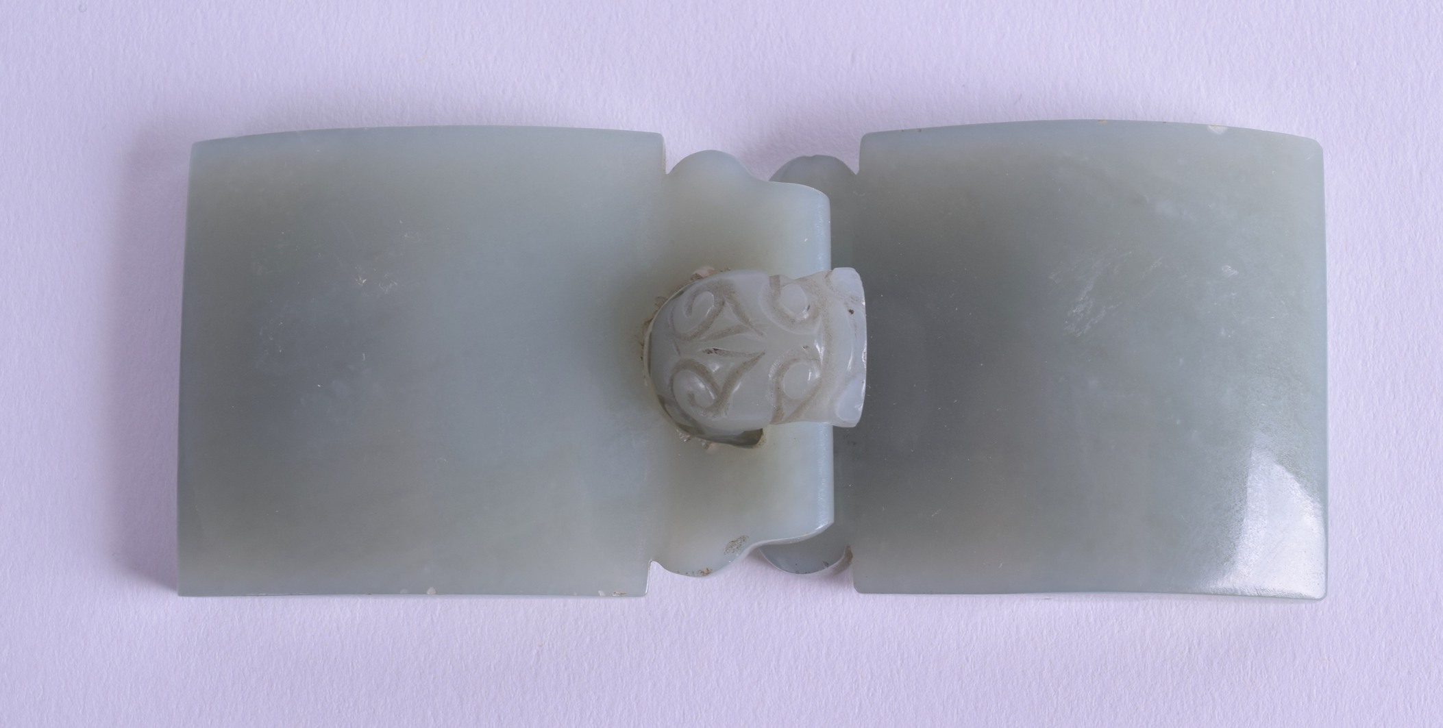 AN 18TH CENTURY CHINESE GREEN JADE BELT BUCKLE formed with kylin mask heads. Overall 11.5 cm x 4.