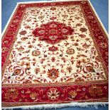 A BEIGE GROUND KESHAN RUG, decorated with extensive foliage. 280 cm x 200 cm.