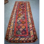 A PERSIAN RUG, decorated with geometric symbols and dogs. 250 cm x 100 cm.