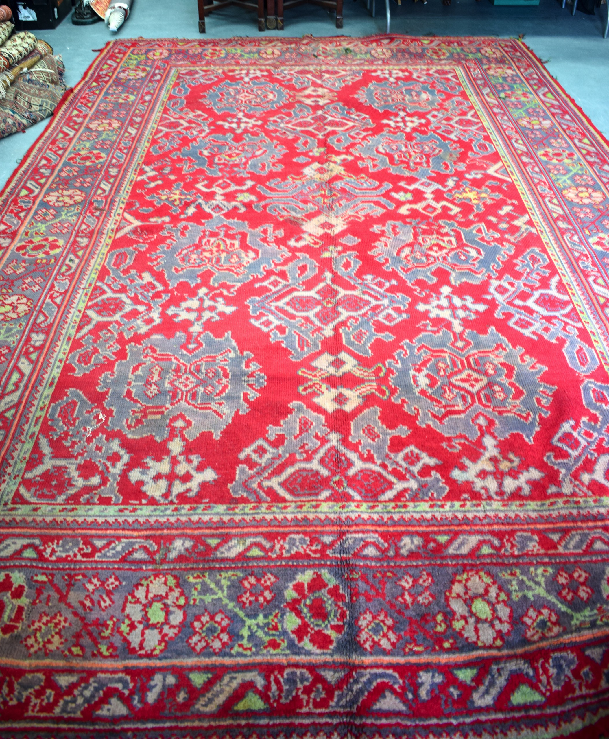 A HUGE RED GROUND PERSIAN RUG, decorated with foliage. 427 cm x 278 cm.