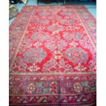 A HUGE RED GROUND PERSIAN RUG, decorated with foliage. 427 cm x 278 cm.