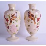 A PAIR OF LATE VICTORIAN ENAMELLED OPALINE GLASS VASES painted with birds perched amongst foliage.