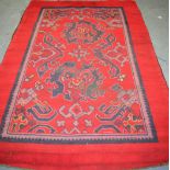 AN ANTIQUE RED GROUND RUG, decorated with stylised flowers. 235 cm x 151 cm.