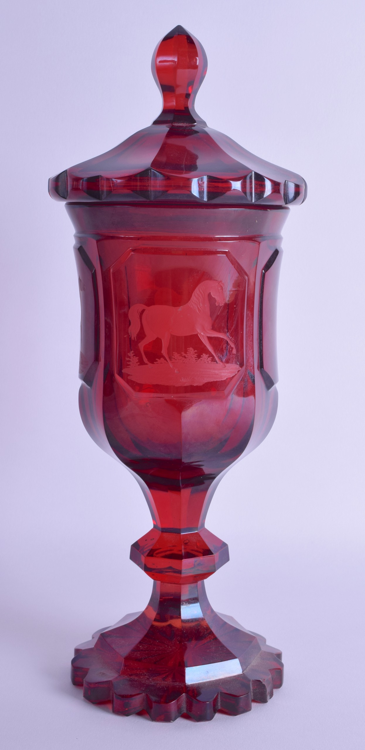 A 19TH CENTURY BOHEMIAN RUBY GLASS GOBLET VASE AND COVER engraved with roaming horses within