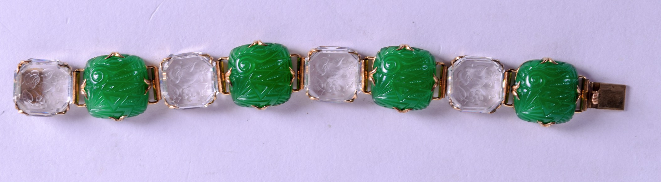 A STYLISH 1920S CRYSTAL GREEN GLASS DECO BRACELET engraved with foliage and stylised motifs. 19 cm