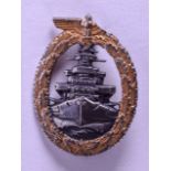 A MILITARY GERMAN BADGE decorated with an eagle and ship. 3.5 cm x 5.5 cm.