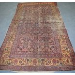 AN ANTIQUE PERSIAN SENNEH RUG, decorated with foliage. 243 cm x 136 cm.