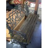 A CAST IRON GARDEN BENCH. 83 cm x 122 cm.