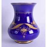 AN EARLY 20TH CENTURY BOHEMIAN BLUE GLASS BULBOUS VASE in the manner of Moser, decorated with gilt