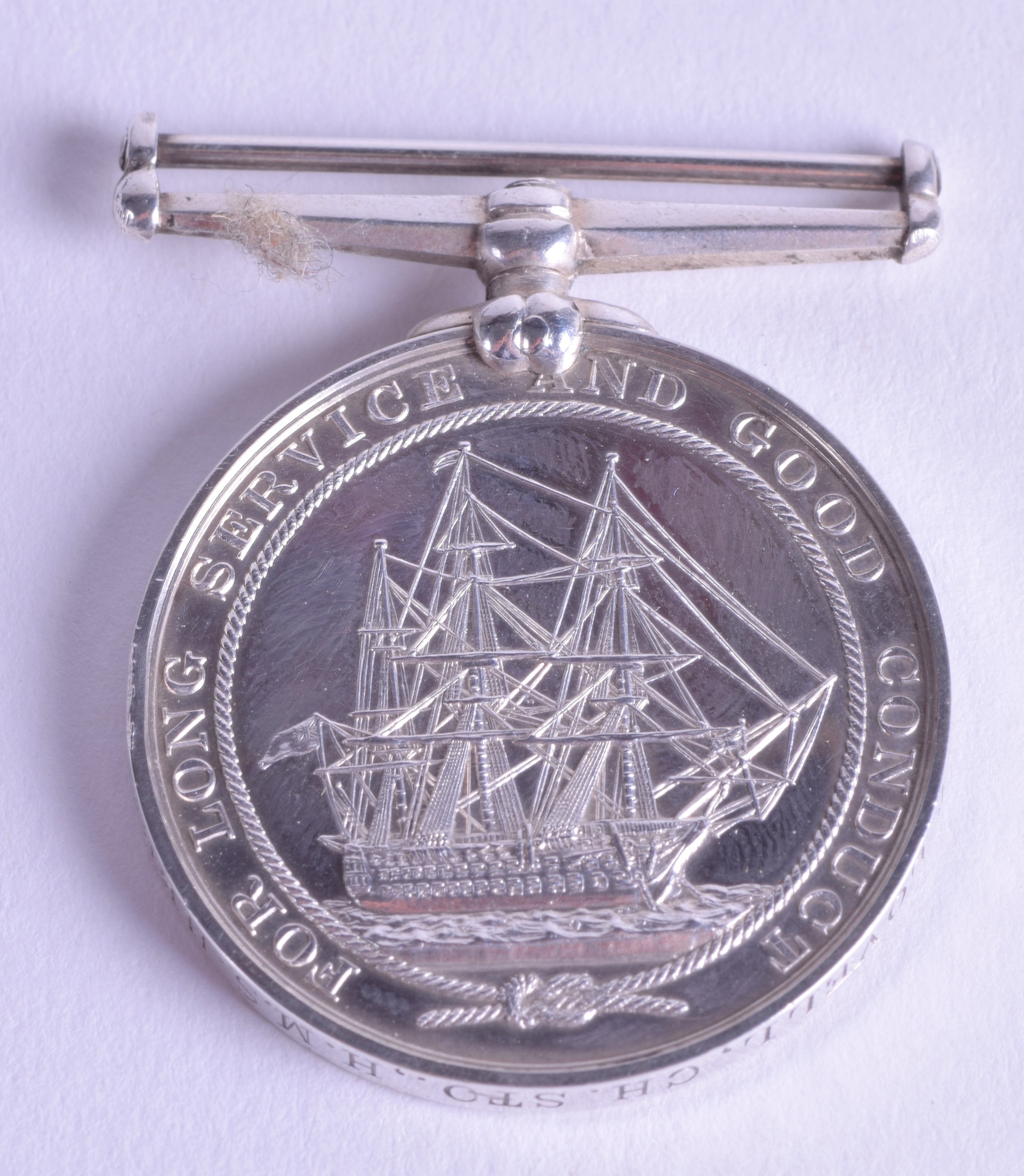 A VICTORIAN NAVAL MILITARY LONG SERVICE AND CONDUCT MEDAL presented to W T Lovell, C H, STO, HMS