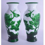 A GOOD PAIR OF EARLY 20TH CENTURY CHINESE PEKING GLASS VASES decorated with birds amongst foliage.