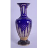 A 19TH CENTURY BOHEMIAN BLUE AND CLEAR GLASS VASE painted with gilt star motifs. 27 cm high.