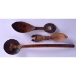 A GROUP OF THREE EARLY 20TH CENTURY CARVED WOOD SPOONS one Persian, the others Continental, with