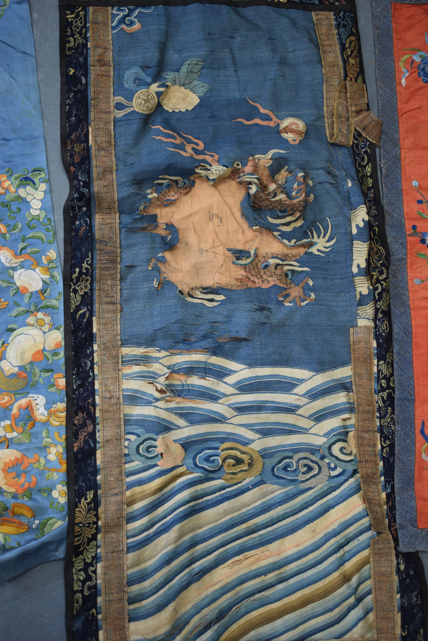 A 19TH CENTURY CHINESE BLUE GROUND EMBROIDERED SILK PANEL, together with a Thangka and two other - Image 4 of 6