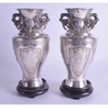 A PAIR OF 19TH CENTURY CHINESE TWIN HANDLED SILVER VASES Qing, with unusual open work raised