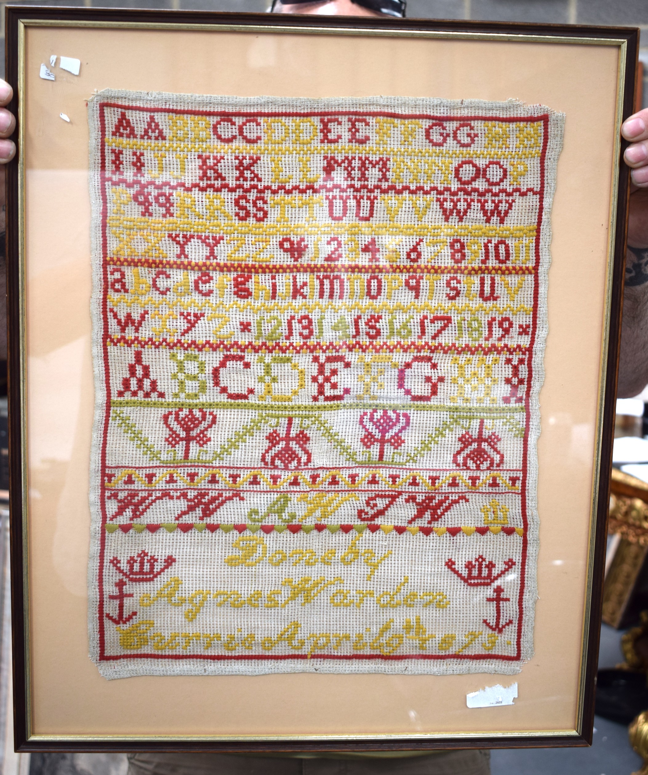 A FRAMED ANTIQUE SAMPLER, circa 1873. 41 cm x 31 cm.