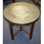 A GOOD EARLY 20TH CENTURY MIDDLE EASTERN BRASS TRAY TOP TABLE, extensive decoration with Islamic