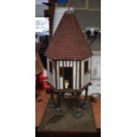 A WOODEN DOVECOTE, formed on six pillars. 79 cm high.