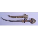 A 19TH CENTURY MIDDLE EASTERN BRASS OVERLAID CURVING KNIFE decorated with extensive foliage and