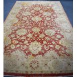 A RED GROUND MUTED OUSHAK ZIEGLER RUG, decorated with motifs. 300 cm x 194 cm.