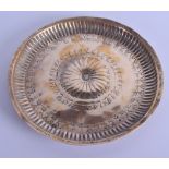 AN EARLY ISLAMIC MIDDLE EASTERN BRASS CIRCULAR DISH decorated with a central floral medallion within