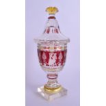 A 19TH CENTURY BOHEMIAN RUBY YELLOW AND CLEAR GLASS VASE AND COVER decorated with figures within