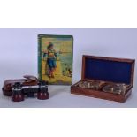 A VINTAGE TIN MONEY BOX, together with a cased compass set and pair of binoculars. (3)