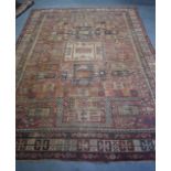 A LARGE EARLY 20TH CENTURY RED GROUND PERSIAN RUG, decorated with symbols and motifs. 288 cm x 214