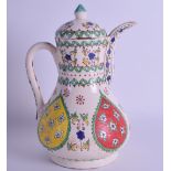 AN ISLAMIC IZNIK STYLE COFFEE POT AND COVER painted with panels of foliage. 20 cm high.