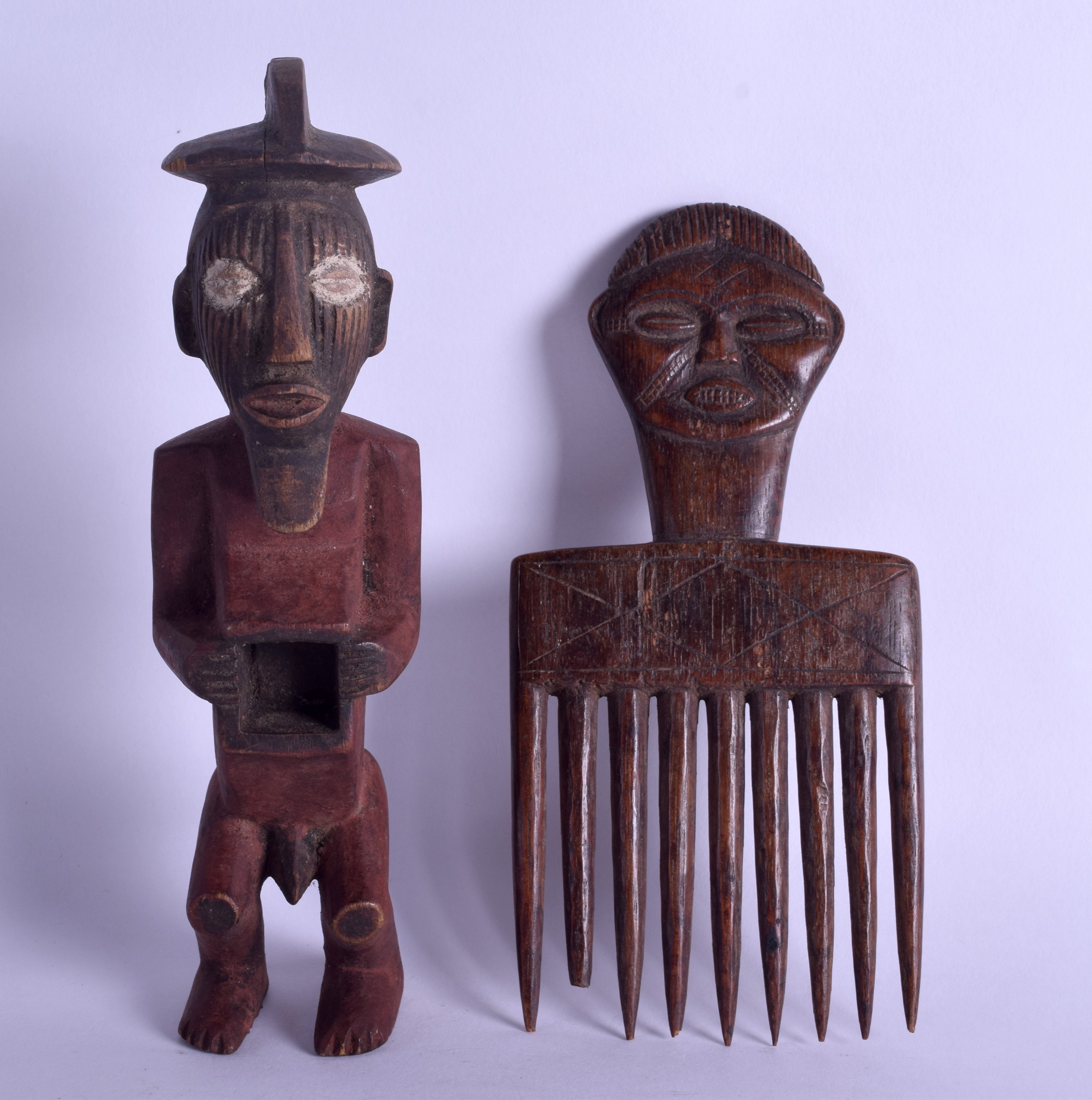 AN EARLY 20TH CENTURY AFRICAN CARVED TRIBAL FIGURAL COMB together with a polychromed wooden