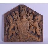 AN 18TH CENTURY ENGLISH CARVED WOODEN CRESTED PLAQUE modelled with a lion and horse beside a shield.