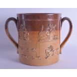 A LARGE MID 19TH CENTURY ENGLISH TWIN HANDLED STONEWARE CUP decorated with figures and hunting