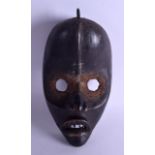 AN EARLY 20TH CENTURY CARVED AFRICAN TRIBAL DAN MASK modelled with teeth exposed. 25 cm x 14.5 cm.