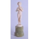 A LOVELY ART DECO CARVED IVORY AND ONYX FIGURE OF A NUDE BOY by Ferdinand Preiss, modelled holding a
