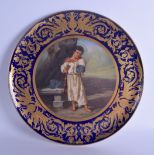 A LARGE 19TH CENTURY VIENNA PORCELAIN CHARGER painted with a standing gypsy boy within a