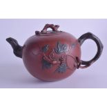 A CHINESE YIXING POTTERY TEAPOT AND COVER decorated in relief with squirrels amongst grape vines. 20