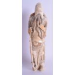 A GOOD 19TH CENTURY CHINESE CARVED IVORY FIGURE OF AN IMMORTAL modelled in armour clutching his