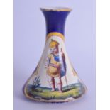 A 19TH CENTURY CONTINENTAL FAIENCE POTTERY VASE painted with a child soldier within a landscape.