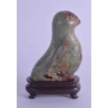 A 19TH CENTURY CHINESE CARVED GREEN RUSSET JADE FIGURE OF A BIRD Qing, Archaic style, incised with