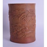 AN EARLY 20TH CENTURY CHINESE CARVED BAMBOO BRUSH POT Bitong, decorated with birds amongst lotus. 16