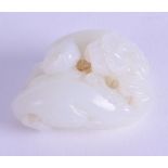 A CHINESE QING DYNASTY CARVED WHITE JADE GROUP depicting two opposing Buddhistic beasts. 5 cm wide.