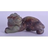 A 19TH CENTURY CHINESE CARVED JADE FIGURE OF A RECUMBANT BEAST Qing, modelled with its head in