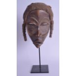AN EARLY 20TH CENTURY AFRICAN TRIBAL IVORY COAST DAN MASK with rope twist head and elongated