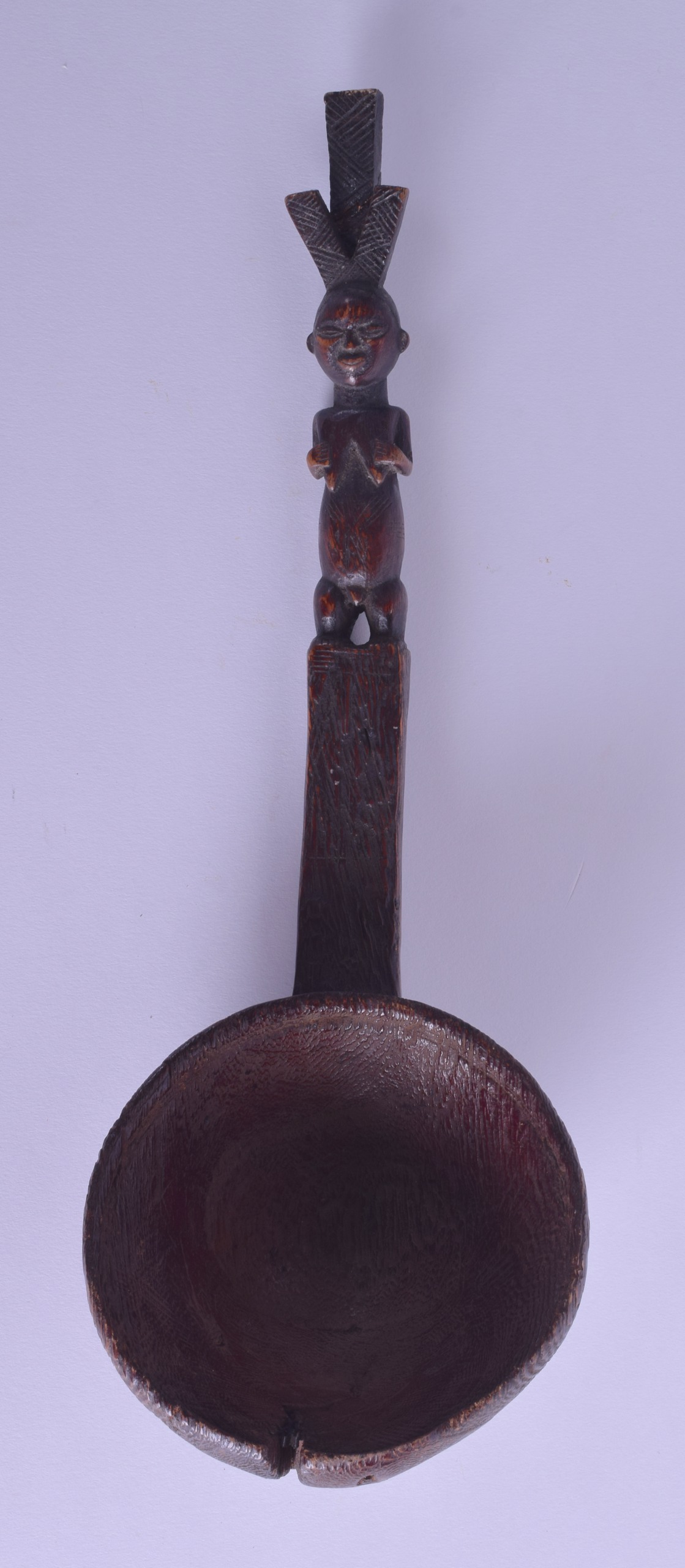 AN EARLY 20TH CENTURY AFRICAN CARVED TRIBAL FIGURAL SPOON modelled as a standing fertility figure