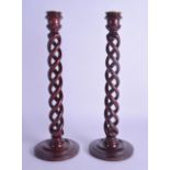 A PAIR OF 19TH CENTURY ENGLISH CARVED BARLEY TWIST CANDLESTICKS bearing label to base Alex Warne