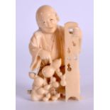 A 19TH CENTURY JAPANESE MEIJI PERIOD CARVED IVORY OKIMONO modelled as a male holding a gourd. 8 cm x